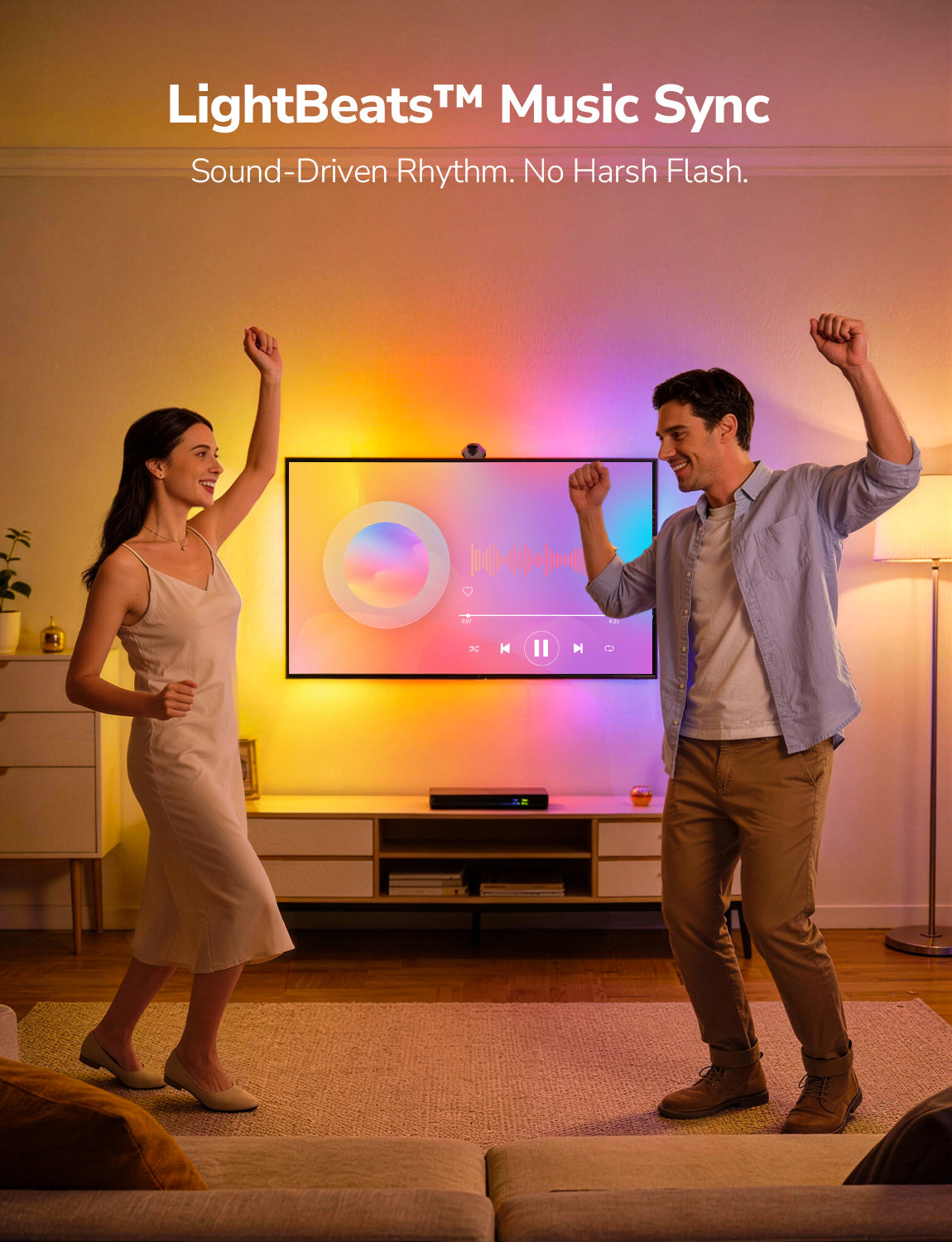 Two people dancing in a living room with a TV screen displaying 'LightBeats Music Sync'.